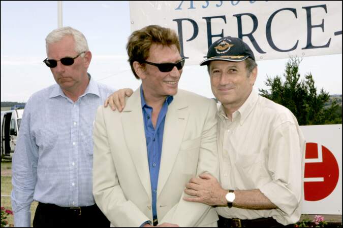 Johnny Hallyday et Michel Drucker lors d'une course au profit de l'association "Perce Neige" en 2004