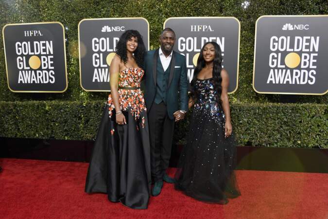 Idris Elba en smoking Ozwald Boateng, avec sa compagne Sabrina Dhowre et sa fille Isan, aux Golden Globes 2019