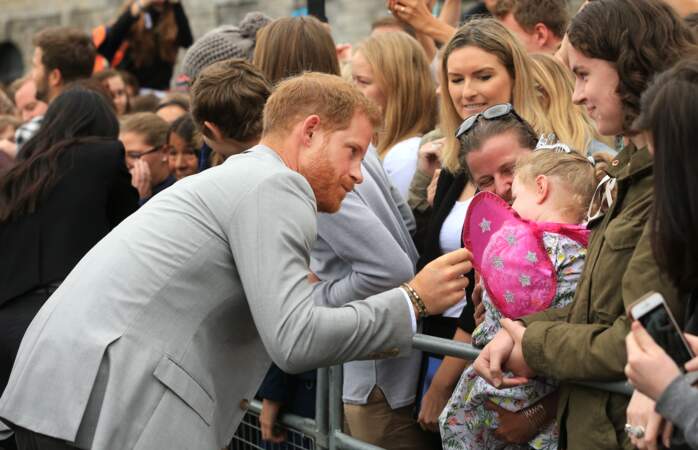 Le prince Harry taquin avec une fillette lors de son voyage officiel avec Meghan Markle à Dublin, le 11 juillet