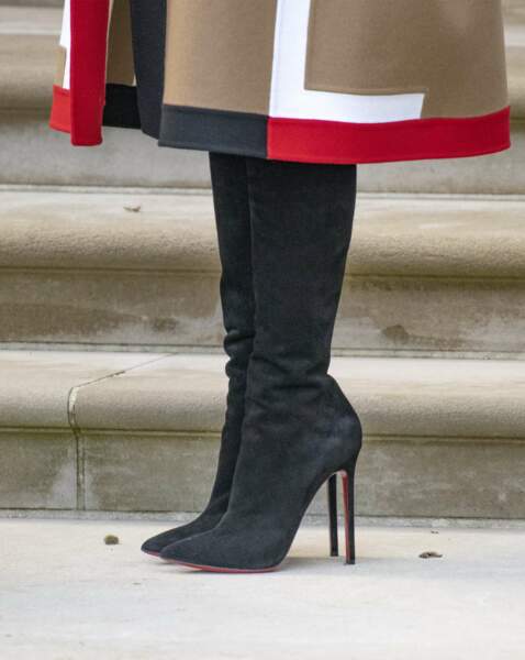 Un manteau à motifs géométriques porté avec des bottes noires à talon aiguill