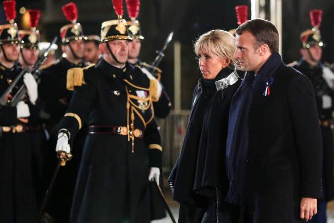 Le manteau de Brigitte Macron est très original : un liseré métallique est cousu sur l'extérieur d'un col officier.