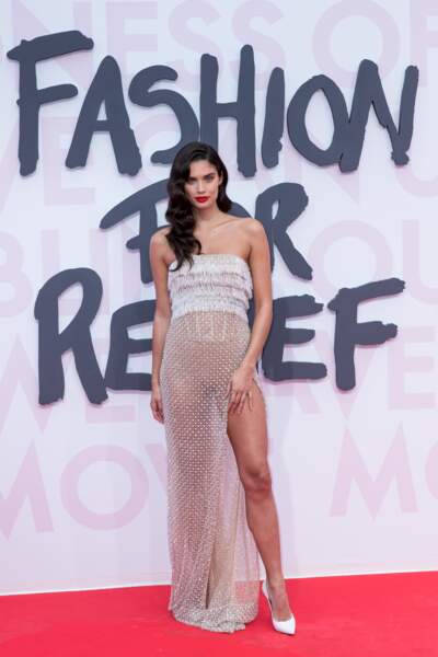 Sara Sampaio lors du défilé de mode "Fashion For Relief" montre ses jambes sous sa robe voilée