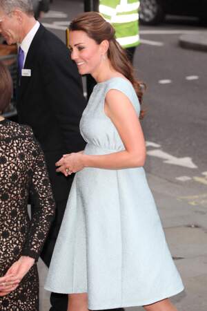 Kate Middleton, enceinte de 6 mois, masquant son ventre avec ses mains jointes, à Londres, le 24 avril 2013.