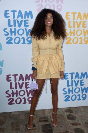 Tina Kunakey, solaire dans une robe courte jaune prend la pose au Etam Live Show