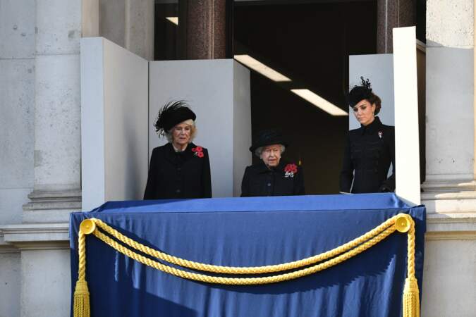 Vêtues de noir, Kate et Camilla arrivent sur le balcon avec la reine, très sobre en ce jour du souvenir.