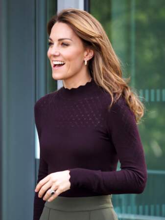 Tout est parfait dans ce look de Kate Middleton : le top violet, la jupe culotte verte, le sac Chanel vintage et les cheveux lissés et couleur miel, le 9 octobre 2019.