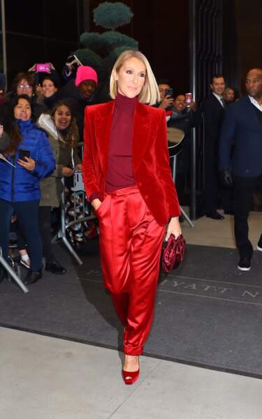 Céline Dion sensationnelle dans un total look rouge en veste blazer velours, pantalon satinée et escarpins vernis dans les rues de New York.
