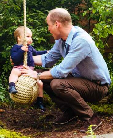 Louis sur la balançoire, avec son papa, le prince William, veillant sur lui.