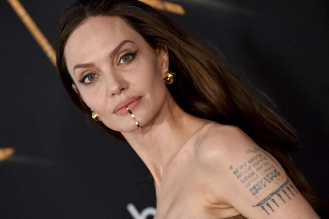 Angelina Jolie dévoile ses tatouages et son bijou sur la bouche à la première du film "Eternals" au studio Marvel à Los Angeles, le 18 octobre 2021.