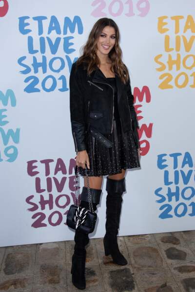 Dans une mini-jupe patineuse en cuir portée avec une paire de cuissardes, Iris Mittenaere a électrisé le photocall du Etam Live Show 2019 au Stade Roland Garros à Paris le 24 septembre 2019.