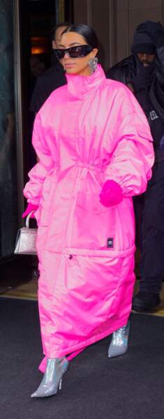 Kim Kardashian emmitouflée dans un long manteau rose flashy à New York, le 9 octobre 2021.