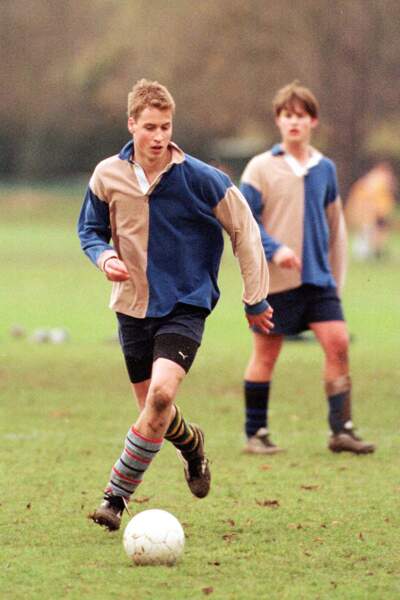 Le prince William, dévoilant son jeu de jambes lors d'une partie de foot au College Eton, en juin 2000.