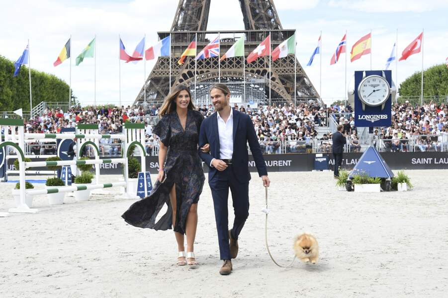Camille Cerf, l'ex Miss France en robe longue fleurie et mules lors du Longines Paris Eiffel Jumping au Champ de Mars à Paris, le 26 juin 2022.