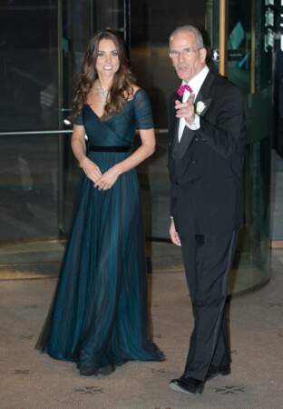 Kate Middleton se glisse dans une robe bleue de la marque Jenny Packham. La duchesse de Cambridge l'associe à un chignon et des boucles d'oreilles à Londres, le 11 février 2014. 