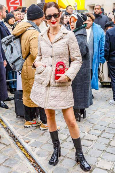 Gala Gonzalez arrive avec une belle rouge et un manteau matelassé au défilé Dior - collection Couture Printemps/été 2023 - à Paris, le 23 janvier 2023