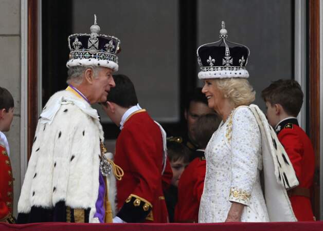 Charles III et son épouse Camilla complices, avec leurs couronnes de roi et reine, sur le balcon du palais de Buckingham, après la cérémonie de couronnement du roi d'Angleterre, à Londres, le samedi 6 mai 2023.