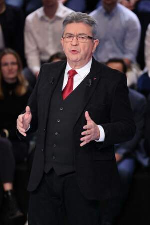 Jean-Luc Mélenchon en costume trois-pièces dont il varie les couleurs, chemise blanche à col fermée et cravate rouge, le 14 mars 2022.