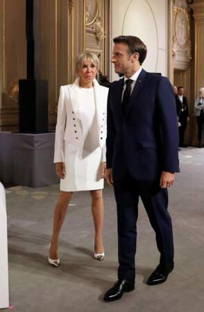 La mère de Tiphaine, Laurence et Sébastien Auzière a choisi de porter une robe droite d’un blanc immaculé coupée au-dessus du genou signée Louis Vuitton,