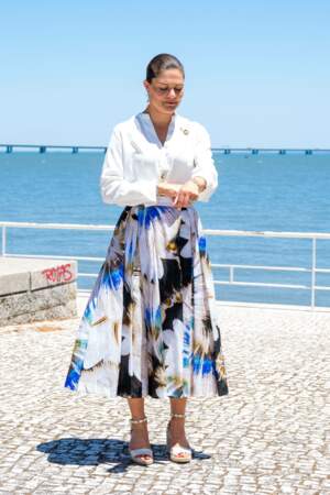 La princesse Victoria de Suède mixe chemise blanche et jupe  trapèze fleurie à Lisbonne, le 28 juin 2022.