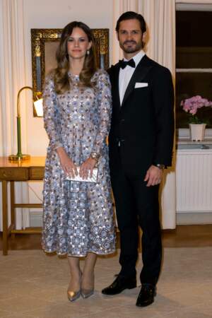 La princesse Sofia tient sa pochette rectangulaire du bout de ses doigts courts et vernis - pochette en cuir et argent disponible dès 690 €, le 25 octobre 2022. 