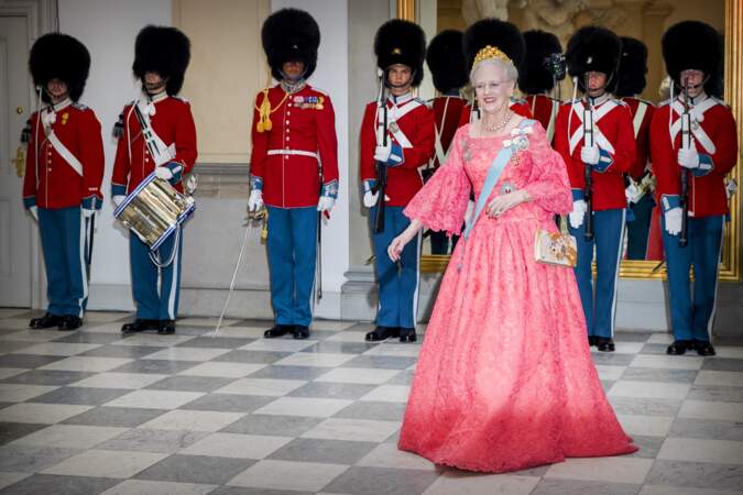 A l'occasion du dîner de gala des 50 ans du prince Frederik de Danemark à Christiansborg en mai 2018, la reine revêt une robe rose saumon à manches bouffantes
